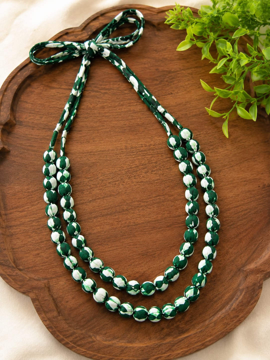 GREEN AND WHITE WOODEN MAIA
